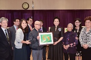 The wife of President Xi Jinping, Peng Liyuan (fourth right), visits senior citizens at TWGHs Jockey Club Sunshine Complex for the Elderly in Wong Chuk Hang, and receives from two elderly representatives their water colour painting as a token of thanks for her visit. Looking on are Deputy Director of the Liaison Office of the Central People's Government in the Hong Kong Special Administrative Region, Ms Yin Xiaojing (first right); the Secretary for Labour and Welfare, Mr Stephen Sui (fifth right); and the Chairman of the Tung Wah Group of Hospitals, Dr Lee Yuk-lun (fourth left).s