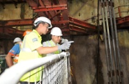 The Secretary for Labour and Welfare, Mr Matthew Cheung Kin-chung (right), is briefed by a representative of the Mass Transit Railway Corporation Limited on the various safety measures implemented at a construction site of the Express Rail Link.