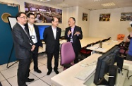 Mr Cheung (third left) is briefed by Mr Kam (second left) on the training procedures in the MTR Corporation's Non-destructive Test Workshop.