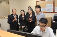 The Secretary for Labour and Welfare, Mr Matthew Cheung Kin-chung, conducted an inspection of a designated office specially set up by the Social Welfare Department in Sheung Shui to facilitate implementation of the Guangdong Scheme for the Old Age Allowance. Picture shows Mr Cheung (first left) and the Director of Social Welfare, Ms Carol Yip (first right), being briefed on the office's operation by the Assistant Director of Social Welfare (Social Security), Miss Maria Lau (second right).