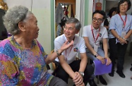 The Secretary for Labour and Welfare, Dr Law Chi-kwong, visited an elderly person in Yuen Long District under the "Celebrations for All" project. Picture shows Dr Law (second left) chatting with the elderly person to understand her living conditions. Next to him is the District Officer (Yuen Long), Mr Edward Mak (third left).
