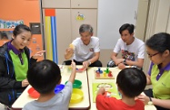 The Secretary for Labour and Welfare, Dr Law Chi-kwong, visited the Tung Wah Group of Hospitals Mr and Mrs Liu Lit Mo Child Development Centre at the Tin Ching Amenity and Community Building at Tin Ching Estate in Tin Shui Wai. Picture shows Dr Law (second left); the Chairman of the Yuen Long District Council, Mr Shum Ho-kit (third left); and staff of the centre interacting with children with special needs.