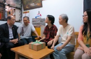 Mr Cheung (first left) visits a person with disabilities (centre) and her parents (second right and second left) in Shun Lee Estate. Mr Cheung was pleased to learn that her physical mobility and communication skills are making remarkable progress after receiving regular and intensive physical/occupational therapy and rehabilitation training.