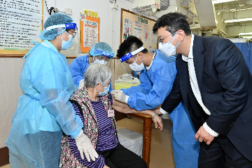 The Secretary for Labour and Welfare, Mr Chris Sun, today (July 5) inspected a COVID-19 vaccination day at a residential care home for the elderly in Ho Man Tin to take a closer look at the latest progress of outreach vaccination for residential care homes. Photo shows Mr Sun (first right) observing the vaccination service provided by a Visiting Medical Officer.